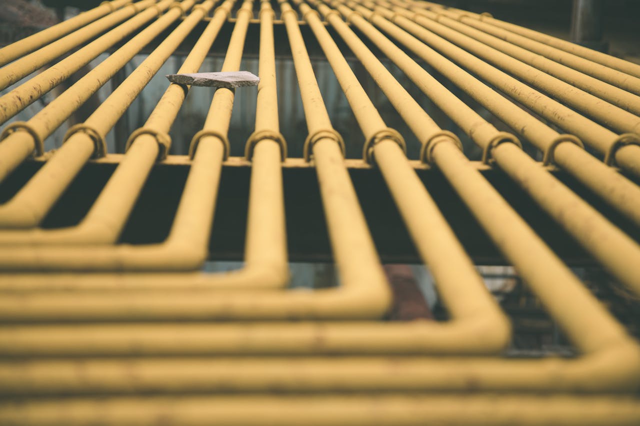 Perspective of multiple yellow pipes in Beijing creating a geometric pattern.